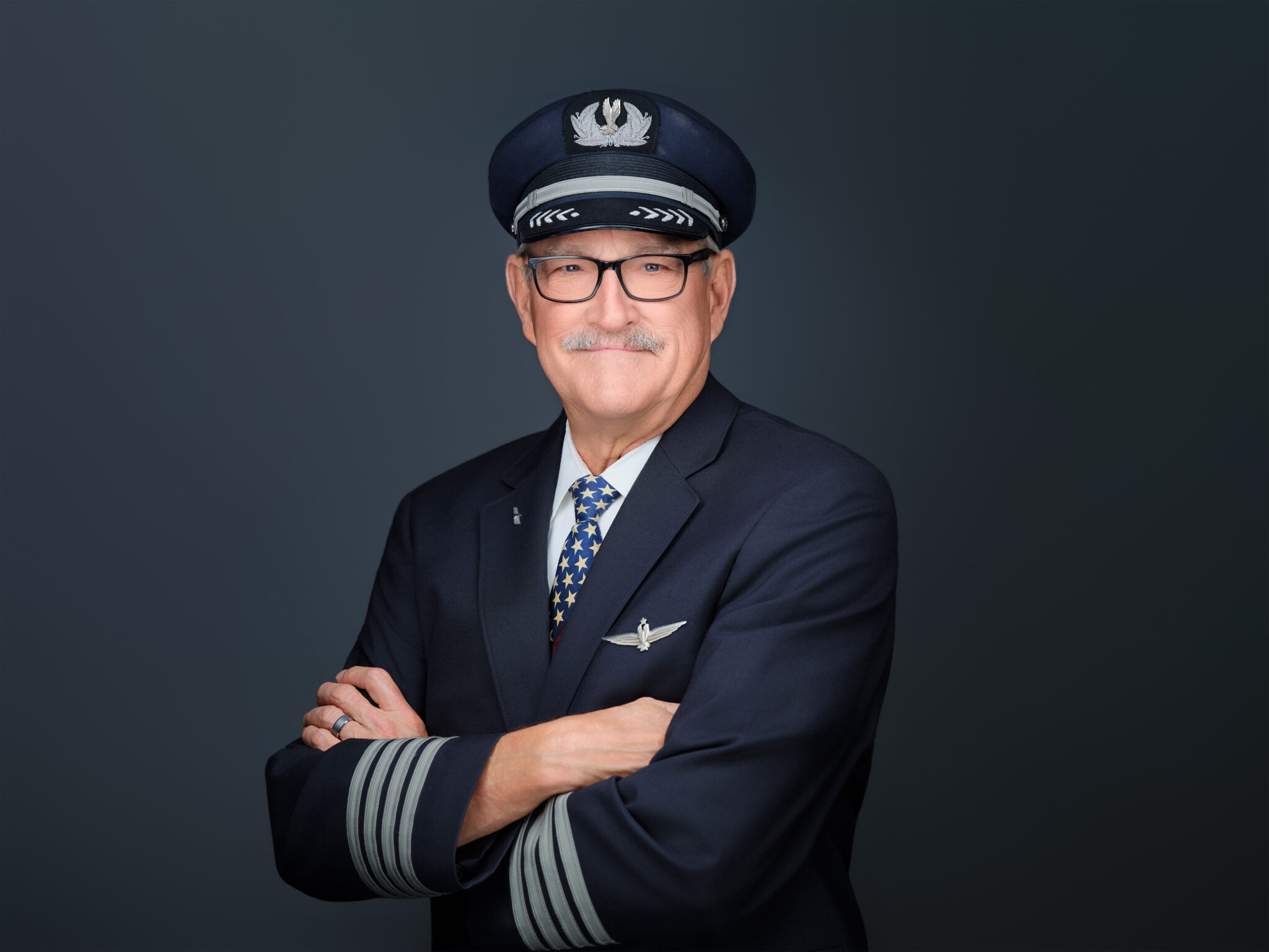 Corporate headshot of a man in a navy suit, taken in our Scottsdale studio