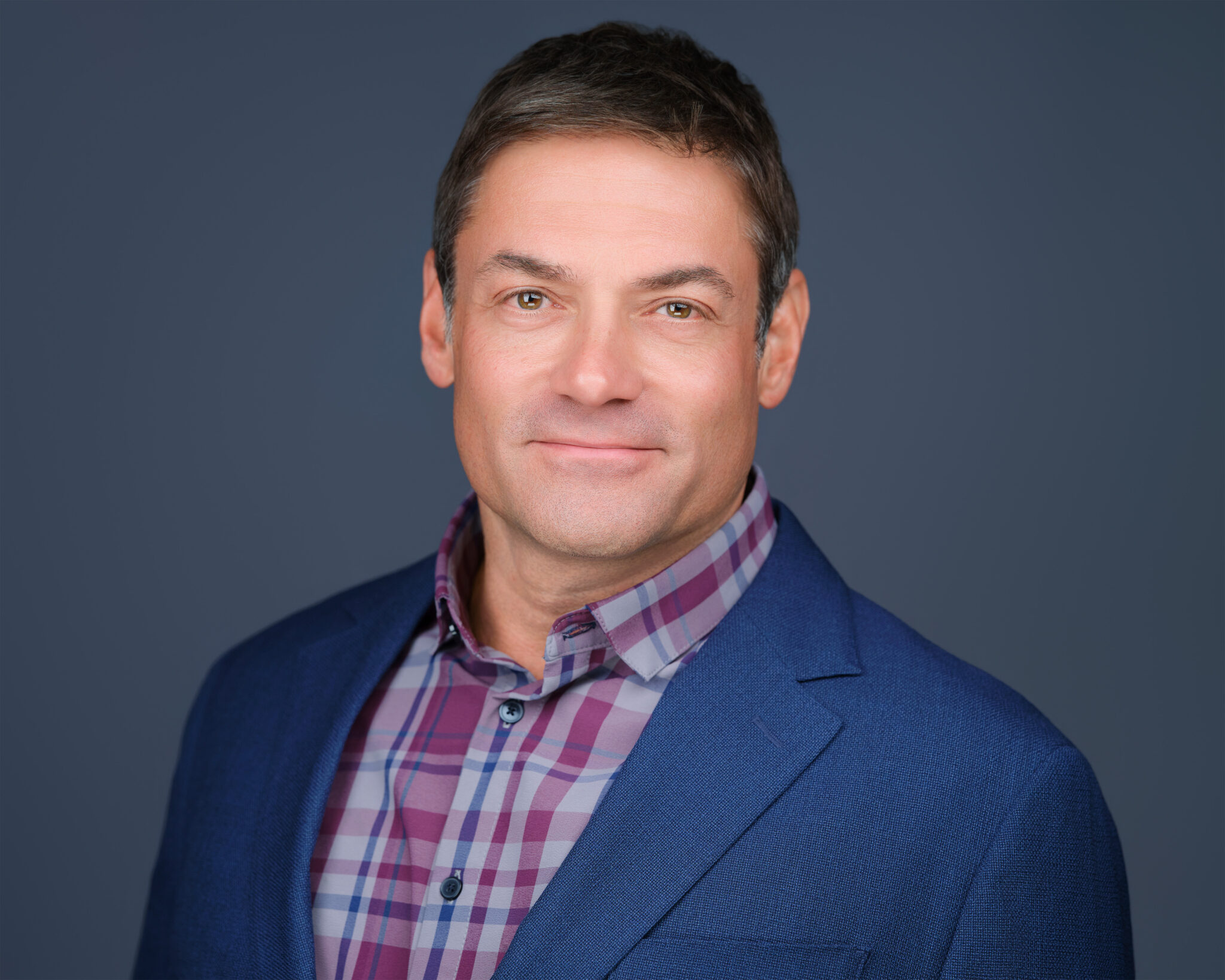 Professional Phoenix headshot of a smiling man in a dark suit