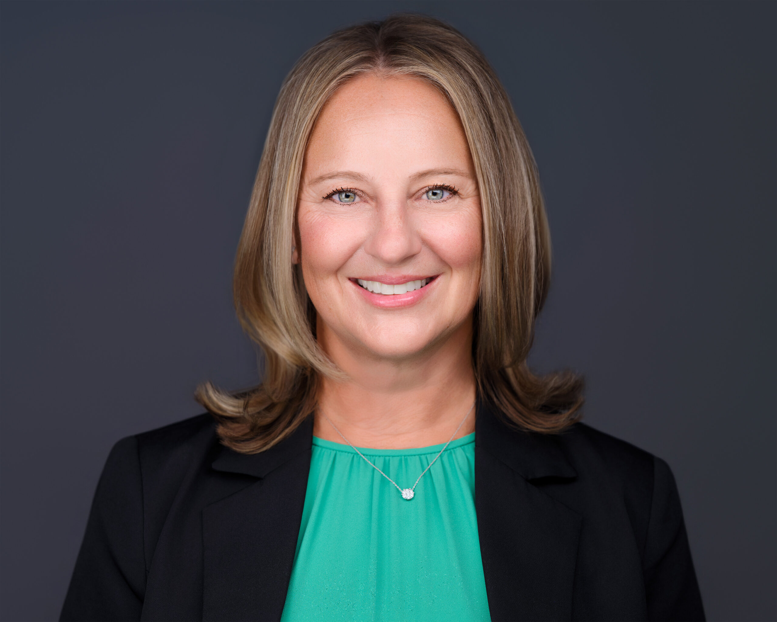 Business portrait of a woman with arms crossed, photographed in Phoenix